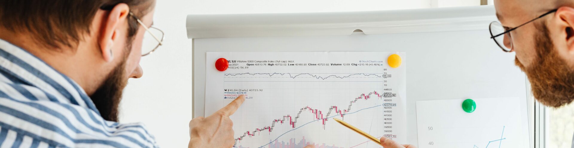men point to the graph