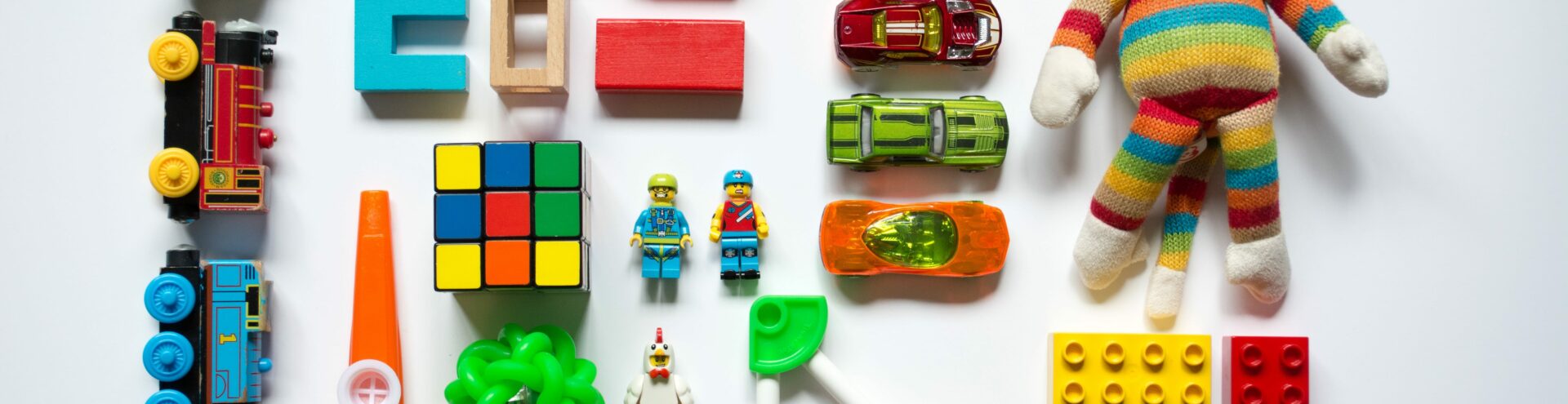 different color toys laying on table