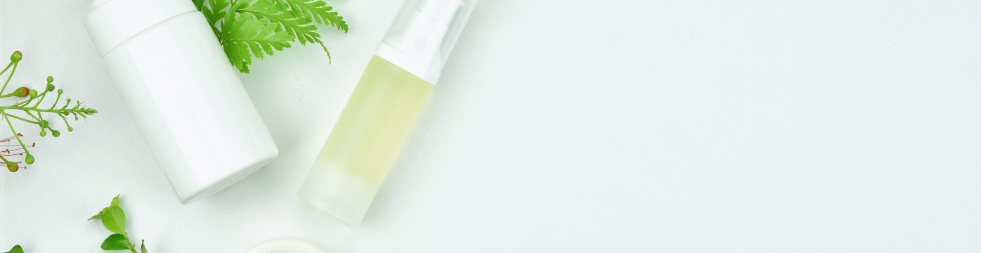 Cosmetic bottle containers with green herbal leaves